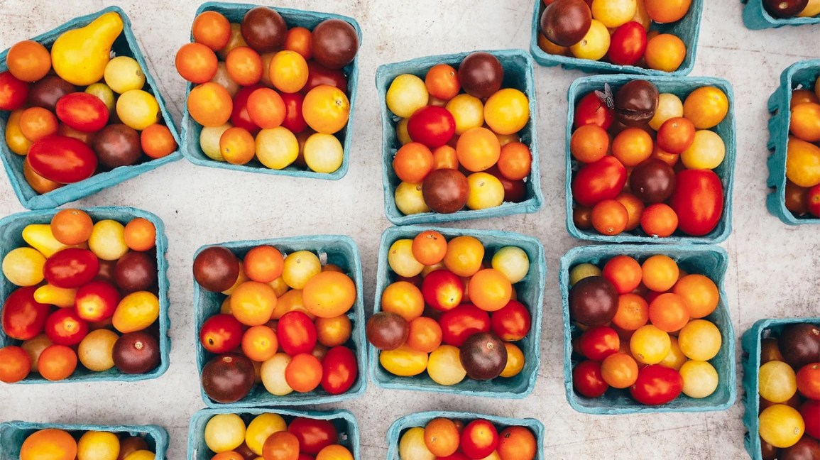 assorted cherry tomatoes in paper containers