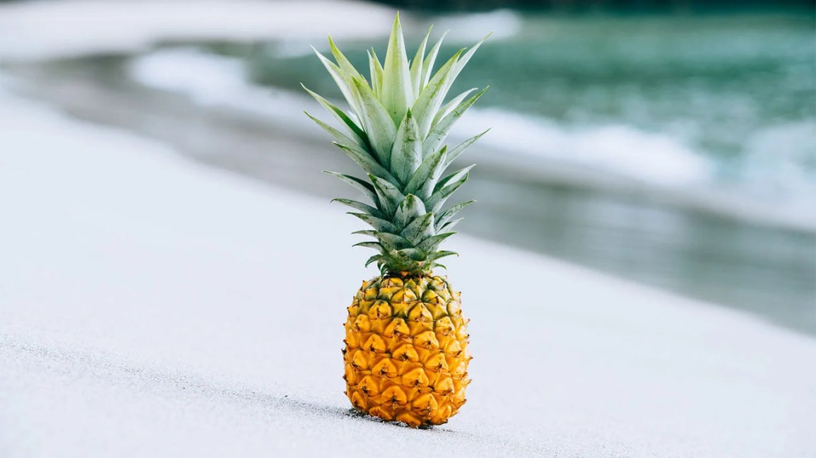 A ripe pineapple on a beach